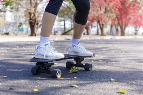 Close Up And Motion Movement Asian Women Surf Skate Or Skateboard Outdoors On Beautiful Morning