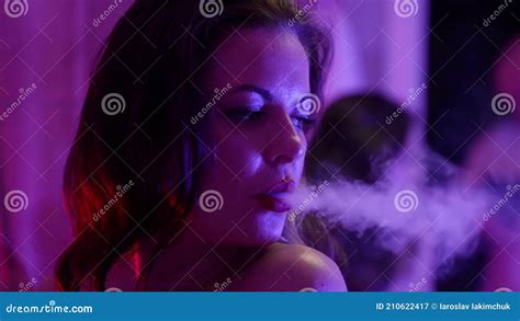 Sensual Woman Is Smoking To Window At Night Inhaling And Exhaling