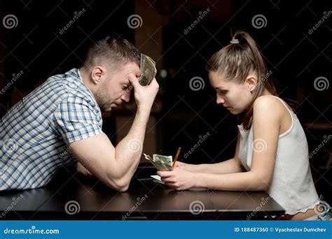 Husband And Wife Sadly Consider Remaining Money In A Difficult Economic