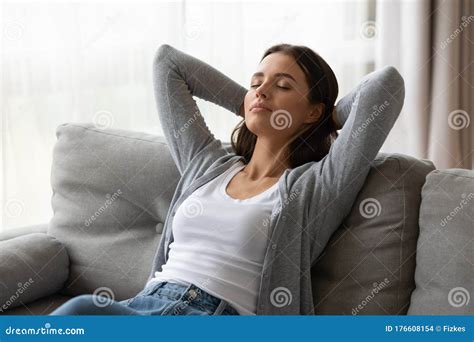 Millennial Girl Relax On Sofa Sleeping Or Daydreaming Stock Photo