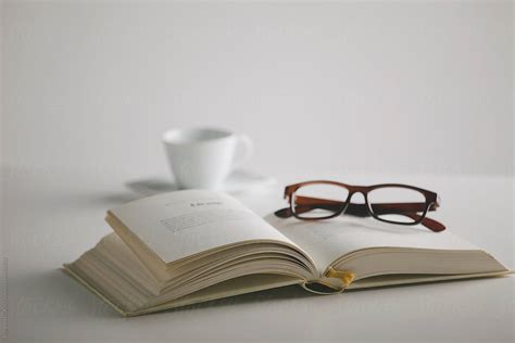 Book Glasses And Coffee Cup On The Table White Background By