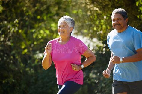 We Love Keeping Healthy Together A Mature Couple Jogging Together On A