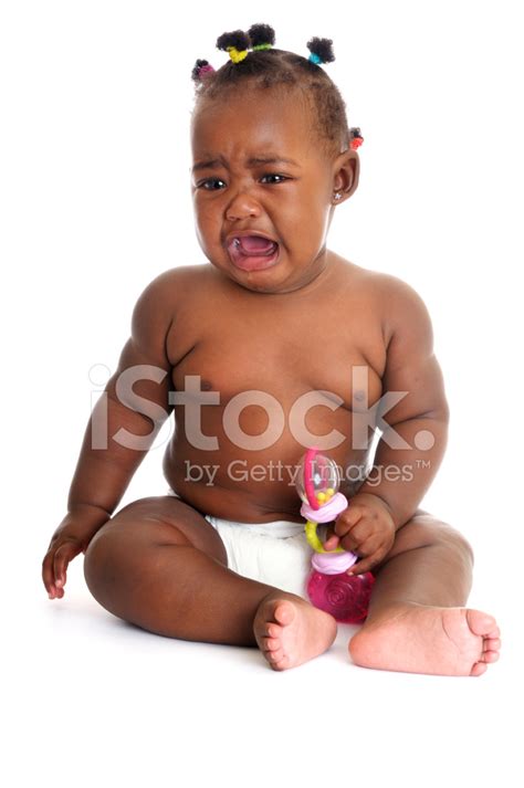 Unhappy African American Baby Girl Crying While Holding A