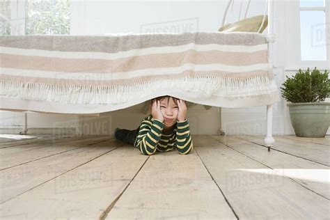 Boy Hiding Under A Bed Stock Photo Dissolve