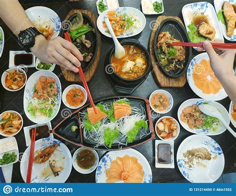 In order to keeping the asian dining. Japanese Food Style, Top View Of Hand Use Chopsticks Holding Salmon Slice With Shrimp Steak ...