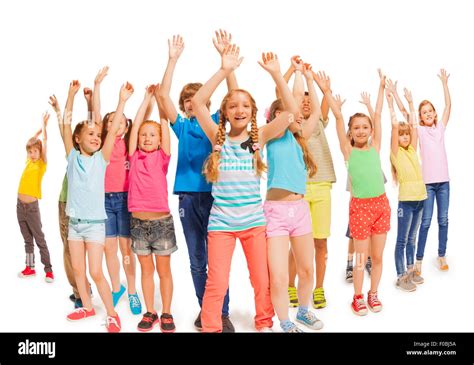 Many Happy Kids Together Raise Hands Up In The Air Stock Photo Alamy