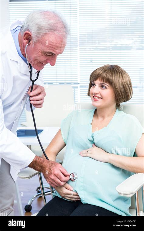 Doctor Examining Pregnant Woman With Stethoscope Stock Photo Alamy