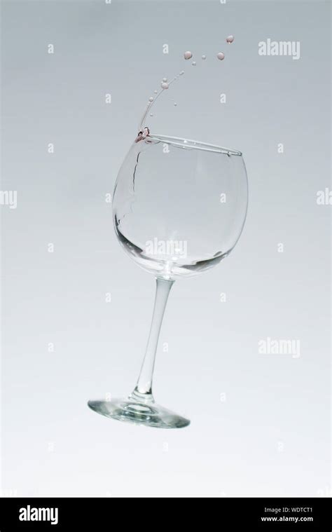 Wine Falling From Glass Against White Background Stock Photo Alamy