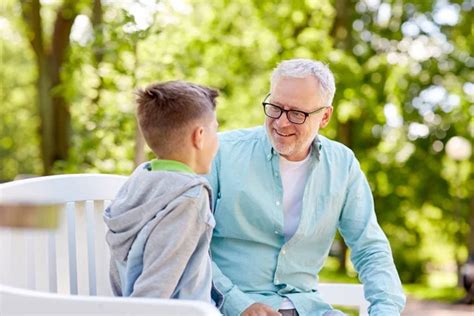 Grandfather And Grandson Talking At Summer Park — Stock Photo © Syda