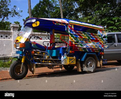 Asian passenger tricycle (widely known as tuk-tuk or tuc-tuc) parked ...