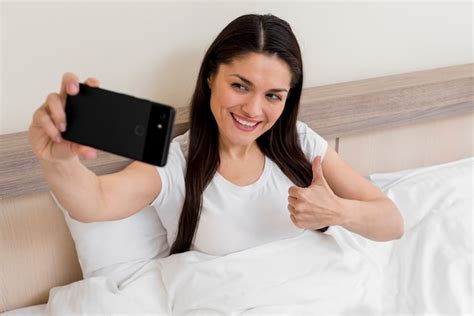 Free Photo Woman Taking Selfie In Hotel Room