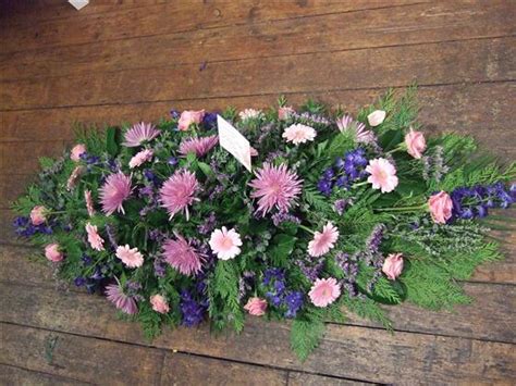 † free delivery available on flying flowers items. Funeral Flowers - Casket Spray in Blue and Pink