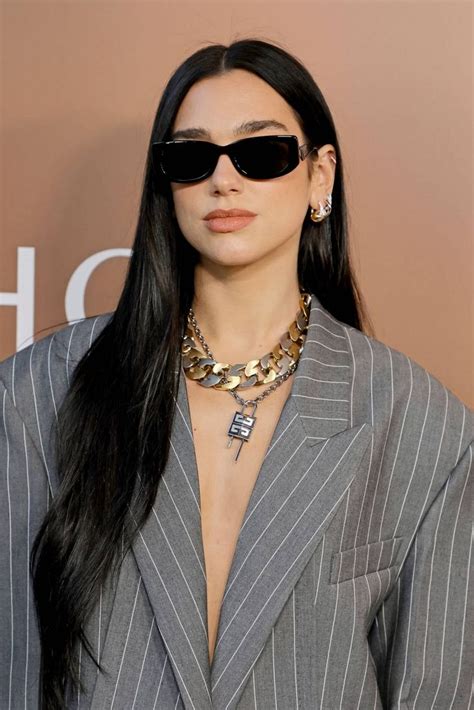 A Woman With Long Black Hair Wearing Sunglasses