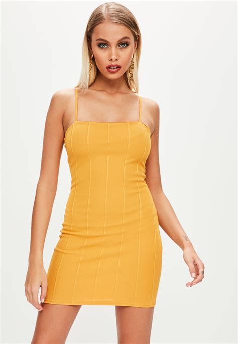 This Yellow Mini Dress Features A Square Neckline Thin Cami Straps And Bodycon Fit Bodycon
