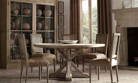 Beautiful dining room features a pair of the urban electric co chisholm lanterns illuminating a restoration hardware salvaged wood trestle rectangular dining table lined with white slipcovered skirted dining chairs. Restoration Hardware | Dining table in kitchen, Dining ...
