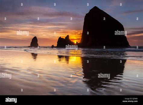Sunset Over Haystack Rock And Other Sea Stacks At Cannon Beach Oregon