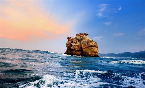 Stone Rock In The Sea Wallpapers And Images Wallpapers Pictures Photos