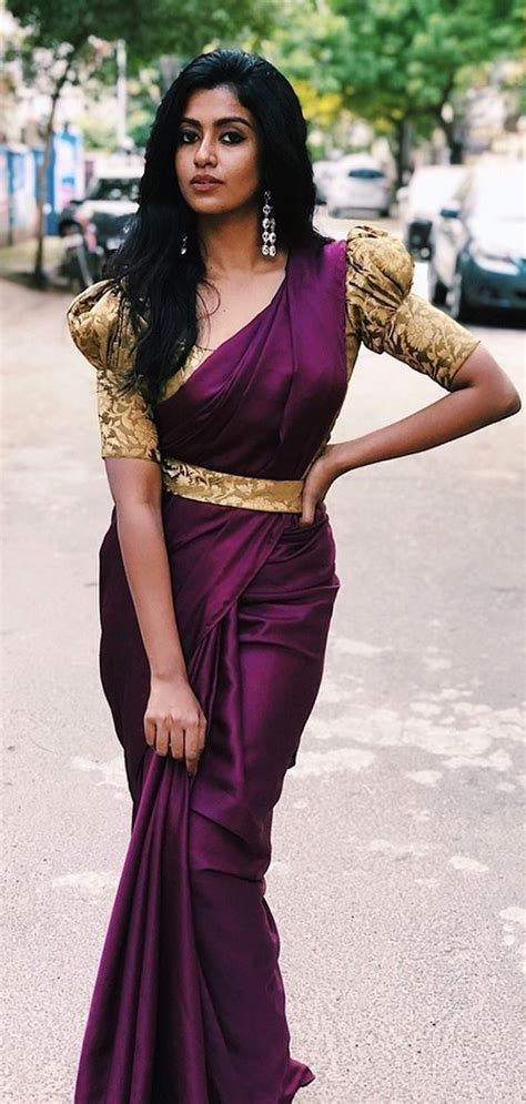 In A Maroon Color Saree Puff Elbow Length Sleeve Blouse Design And Hip