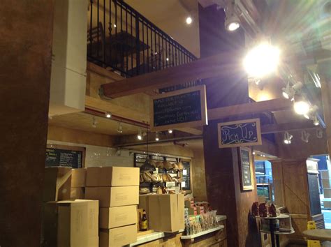 the inside of a restaurant with lots of boxes on the counter and stairs