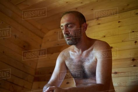 Mature Man Sitting In Sauna With Head Down Stock Photo Dissolve