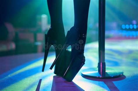 Young Woman Pole Dancing Striptease With Pylon In Night Club Beautiful