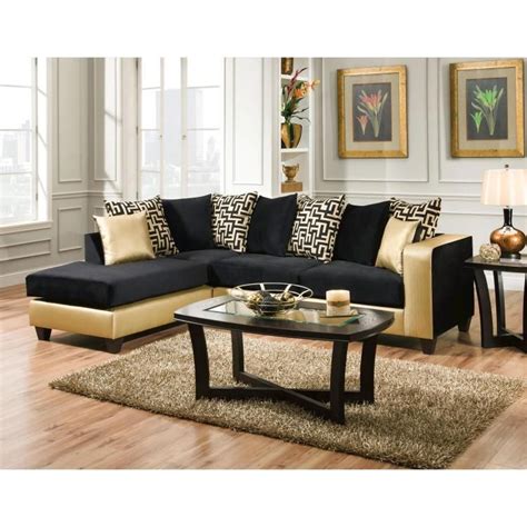 This living room features light gold hued sofas, dark wood coffee table, and dark wood dining set in background, sharing space with white cabinet kitchen. Luxurious Black And Gold Sofa For Living Room Ideas | Modern sofa living room, Gold sofa, Living ...