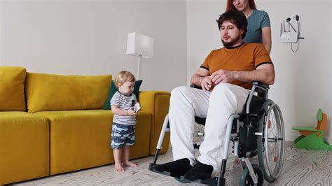 Wife Takes Care Of Her Husband In A Wheelchair And Gives Her Little Son