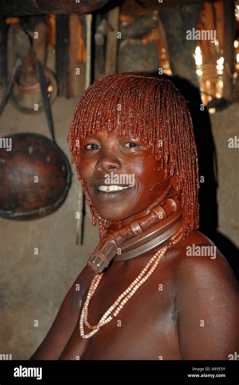 Woman Of The Hamar People With Red Clay In Her Hair And Heavy Necklace