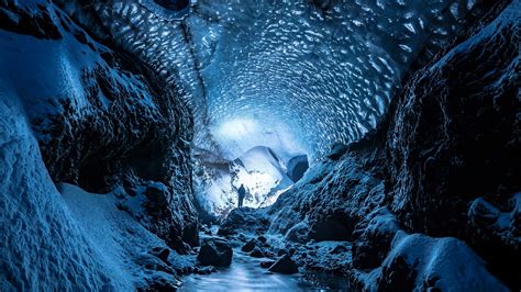 Download Wallpaper 2560x1440 Glacier Cave Man Ice Snow Widescreen 169 Hd Background