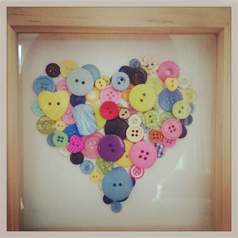 A Wooden Frame With Buttons In The Shape Of A Heart