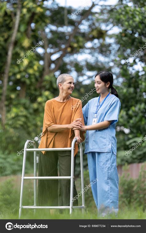 Nurse Caregiver Help Elderly Walk Using Walker Elderly Touching