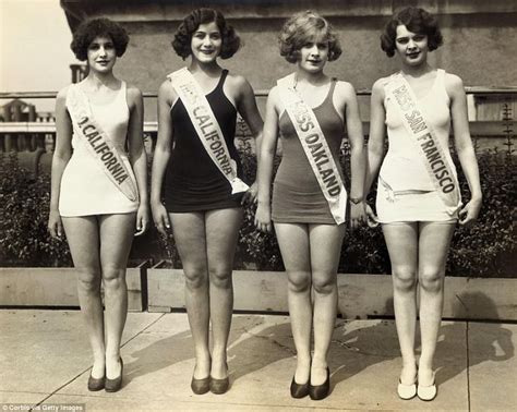 Three Women In Bathing Suits Are Standing Next To Each Other And One Is