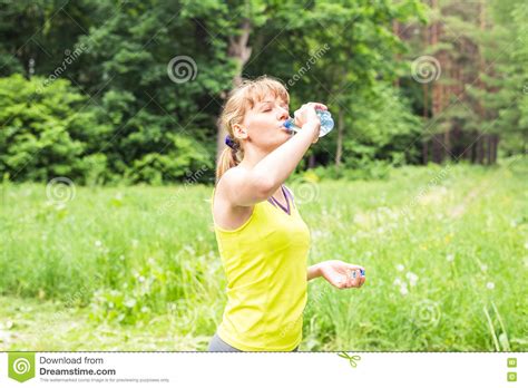 Beautiful Fitness Athlete Woman Drinking Water After Work Out