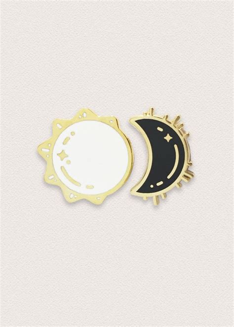 Two Enamel Pins With The Moon And Sun On Them One Black And One White