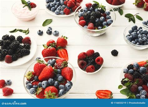 Mixed Berries In Glass Bowls On White Wooden Table Stock Image Image