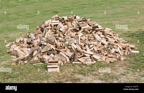 Pile Of Split Firewood On Green Grass Stock Photo Alamy