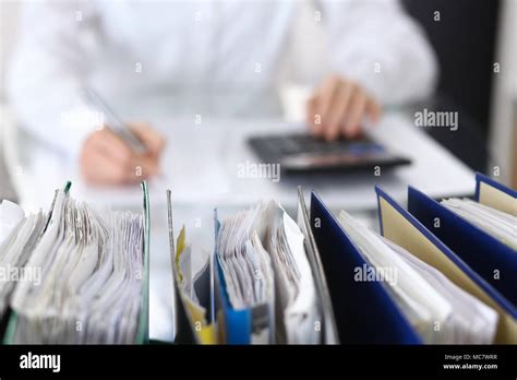 Binders With Papers Are Waiting To Be Processed With Businesswoman Or