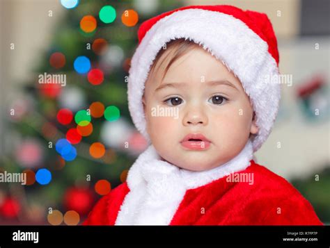 Portrait Of A Beautiful Little Santa Claus At Home Sweet Baby Boy