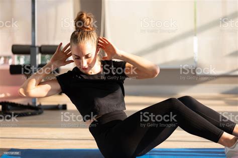 Young Sports Woman Doing Abs Exercises Sit Up Workout In Gym Stock