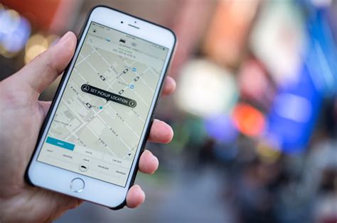 A list of the best apps to download before you travel to new york city. Man Using The Uber Taxi App On Iphone In Nyc Stock Photo ...