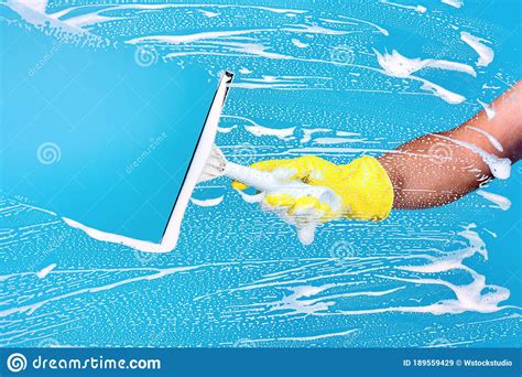 cleaning conept hand cleaning glass window pane with detergent stock image image of squeegee