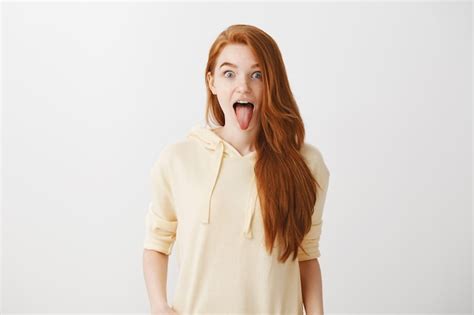 Free Photo Funny Playful Redhead Girl Showing Tongue And Looking Excited