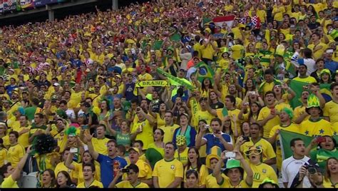 a large group of people in yellow and green shirts