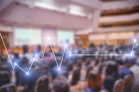 Blurred Background Of Business People In Conference Hall Or Seminar Room With Stock Market