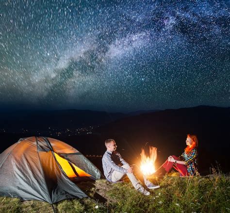 Premium Photo Night Tent Camping Couple Tourists Sitting By Campfire