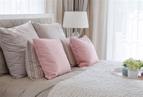 Pink Pillows On Bed With White Tray Of Flower At Home Bed Pillows