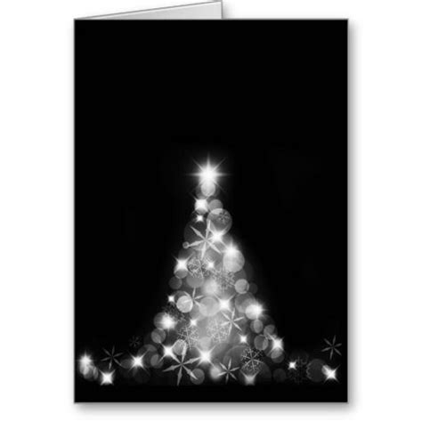 A Black And White Christmas Card With A Tree Made Out Of Lights In The