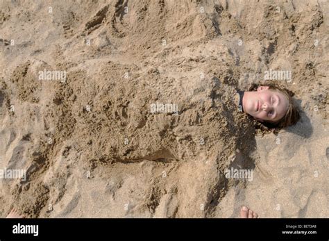 Girl Buried In Sand Hi Res Stock Photography And Images Alamy