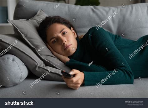 person lying on sofa looking sad over 1 383 royalty free licensable