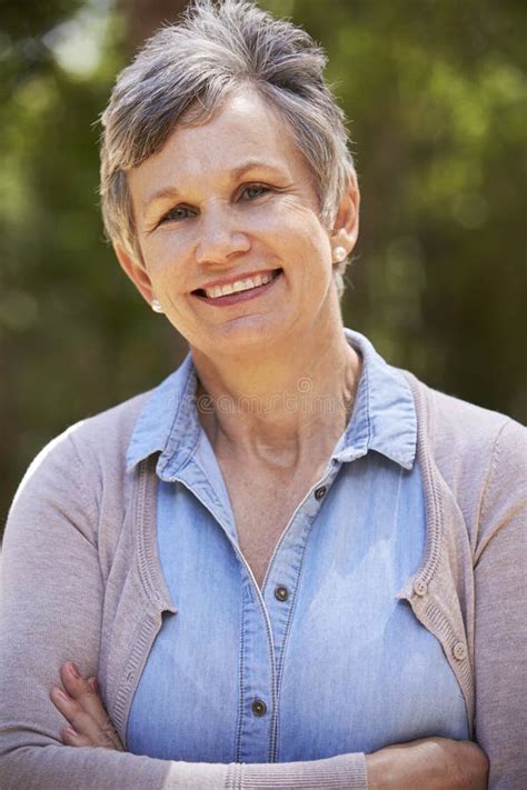 Outdoor Portrait Of Mature Woman With Folded Arms Stock Photo Image Of Happy Portrait